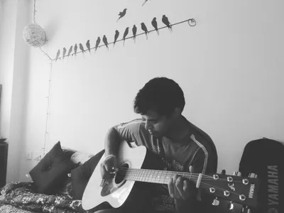 Playing acoustic guitar at home